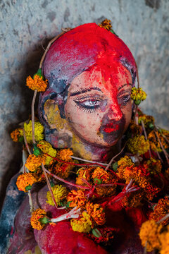 Vibrant statue adorned with colorful marigold flowers