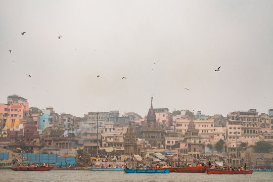 Riverfront view of Varanasi with boats and historic architecture
