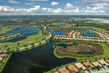Obraz premium Consequences of natural disaster. Heavy flood with high water surrounding residential houses after hurricane Ian rainfall in Florida residential area