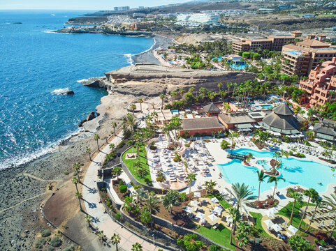 Drone view of the coastline near La Caleta, Tenerife, Canary Islands, Spain, with luxury resorts, rocky shore