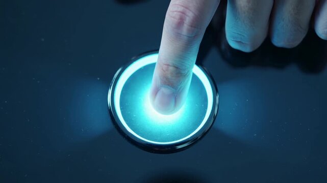 Futuristic digital control a human finger illuminates a vibrant blue button on a dark console