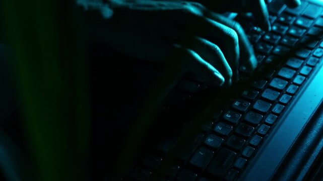 Business woman typing the fingers on keyboard with writing the pen in hand . Low key shadow with green color art lighting. Closeup series of videos from different angles