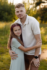 Fototapeta premium Father Embracing Daughter In Field, Gentle Wrap Of Arms, Affectionate Face Contact, Summer Dress And Relaxed Vibe, Supportive Parental Comfort During Quiet Outdoor Moment