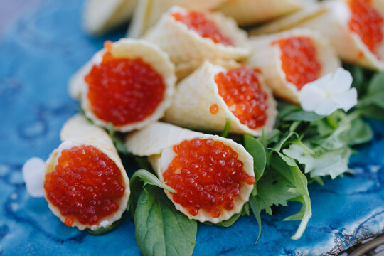 Exquisite Red Caviar Appetizers on Blue Plate