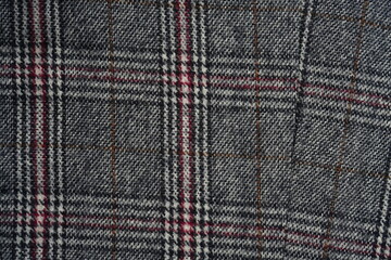 Fototapeta premium macro texture of plaid fabric with classic tweed pattern. Close-up of woven textile showing detailed structure in neutral grey tones with subtle lines. Elegant and timeless background perfect for fash