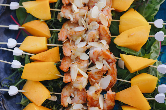 Shrimp and Mango Skewers on Leafy Greens