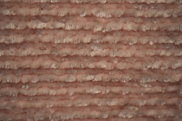 macro texture of soft pink plush fabric. Close-up of cozy textile with delicate fibers and warm pastel tones. Smooth, soft surface creates a calm and comfortable background perfect for fashion, home d © Анна Климчук