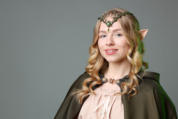 Obraz premium Beautiful elf girl on grey background, space for text