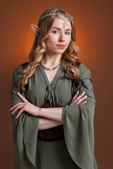 Obraz premium Portrait of beautiful elf girl on brown gradient background