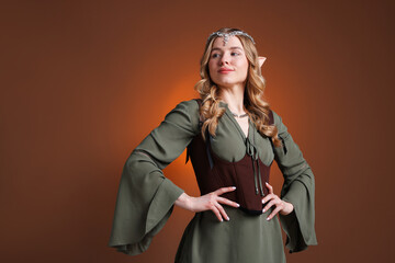 Obraz premium Portrait of beautiful elf girl on brown gradient background, space for text