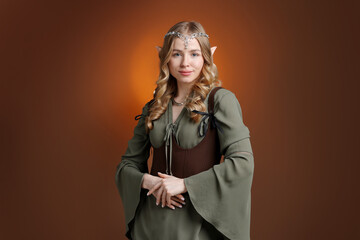 Obraz premium Beautiful girl dressed as elf on brown gradient background