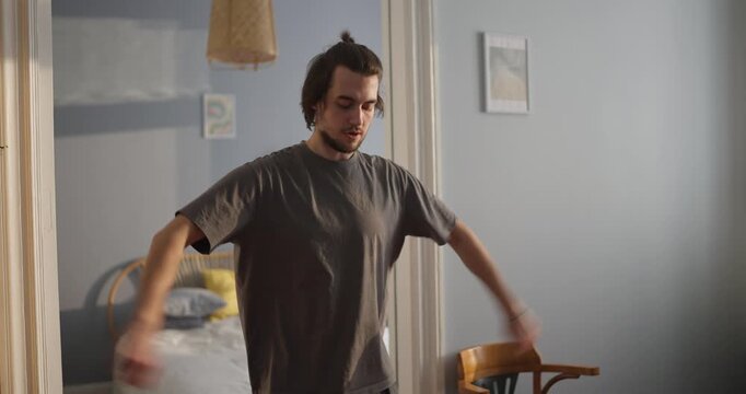 a young man stretches, embracing the morning's calm and fluidity through graceful movements