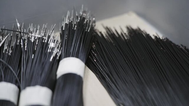 Background of numerous black cables neatly bundled