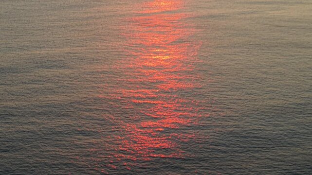 Cinematic aerial reveal of a breathtaking sunset over the Mediterranean Sea, featuring vibrant orange and gold light reflecting on the water&rsquo;s surface. 