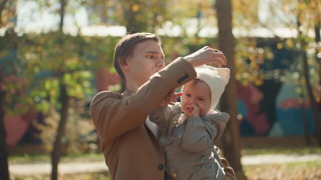Dad repairs cap. Father is repairing his hat attentively. Dad meticulously fixes and restores his favorite hat lovingly. Father carefully and skillfully mends wornout hat with great attention