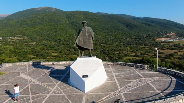 Drone shot of the historic Soldier of 1940 statue in Kalpaki Epirus Greece, military war memorial landmark overlooking the mountains