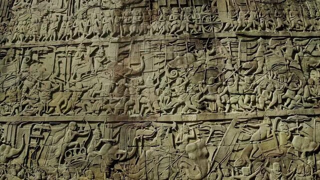 Stone bas relief depicting a mythological or historical battle at a cambodian temple