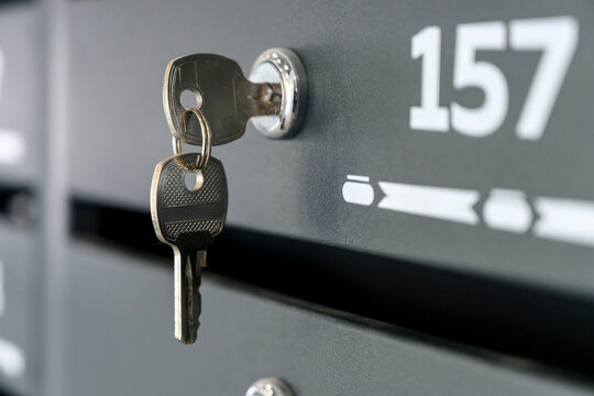 Key inserted in mailbox lock with number 157 visible on front panel
