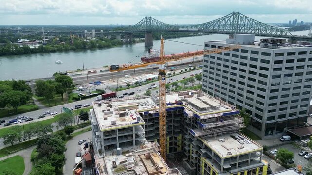 4K aerial drone flying past construction crane toward Jacques Cartier Bridge in Montreal