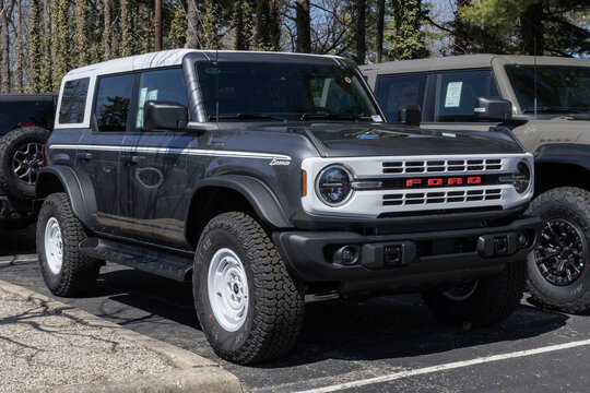 Ford Bronco Heritage 4-Door 4X4 SUV display at a dealership. Ford offers the Bronco with a 2.7L EcoBoost V6 engine. MY:2026