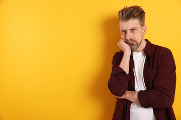 Resentful man on yellow background. Space for text © New Africa