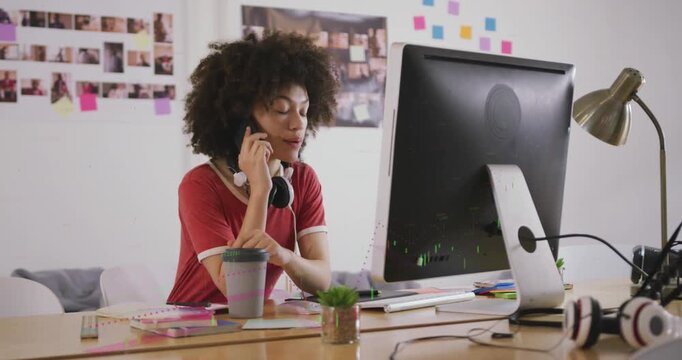 Animation of biometric fingerprint over businesswoman using phone headset and laptop