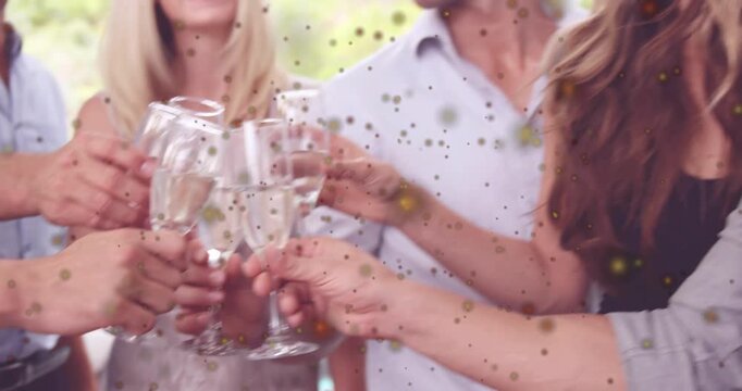 Six adults clinking flutes clinking causing confetti overlay camera pulling back celebrating events