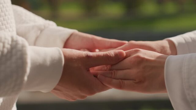 Family vows exchanged. Lovers exchange rings near water. Intimate family ceremony with delicate embraces and natural beauty. An emotional scene of love and commitment by tranquil lakeside