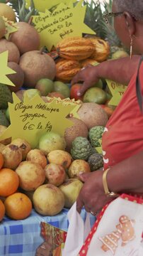 Vertical Action Shot of Tropical Fruit Shopping in Martinique: Real-Time View of Cacao and Guava Stall in Fort-de-France