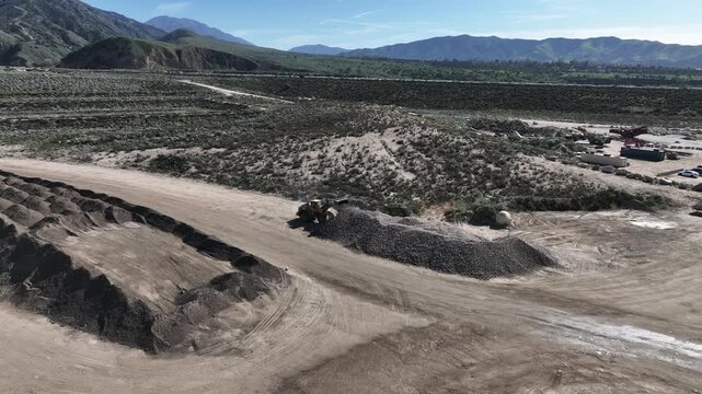  A Man Flying his UAV to survey the local earthquake faults looking at the San Andreas Fault Area near the Seven Oaks Dam, Marks Field,  and the Mentone Quarry 