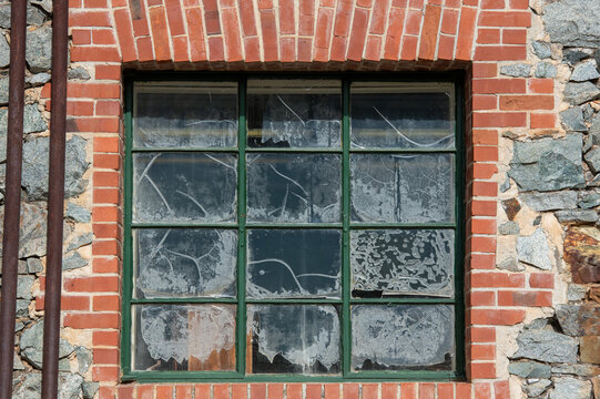 Old brick window in a stone wall