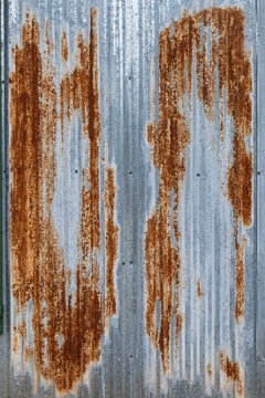 Rust patterns on metal surface in urban setting