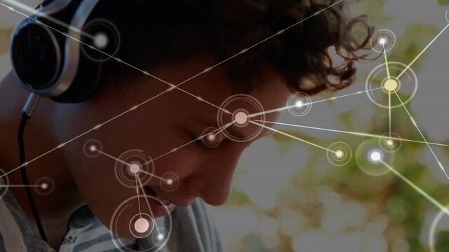 Animation of network of connections over caucasian student using headphones