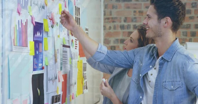 Animation of statistical data processing over caucasian man and woman discussing at office