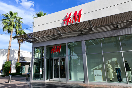 H&M retail clothing store exterior with glass entrance and signage, representing fashion retail, apparel sales, and shopping center storefront activity