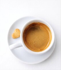 Fototapeta premium Minimalist espresso coffee cup with heart-shaped cookie Concept of love, morning routine, cozy moments cup of coffee