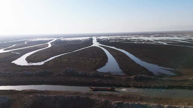 The Al-Jubaysh Marshes, located in Dhi Qar, Iraq, are part of the Mesopotamian marshlands, one of the world's largest wetland ecosystems. Known for their rich biodiversity, these marshes are home to u