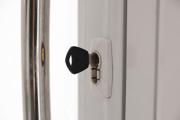 Naklejka premium Door with keys and metal handle indoors, closeup
