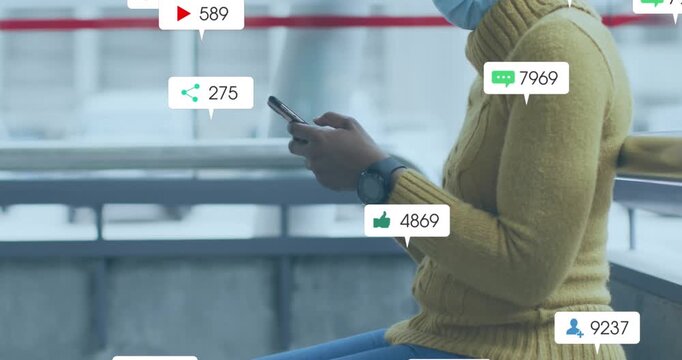 Animation of social media icons with numbers over african american woman using smartphone