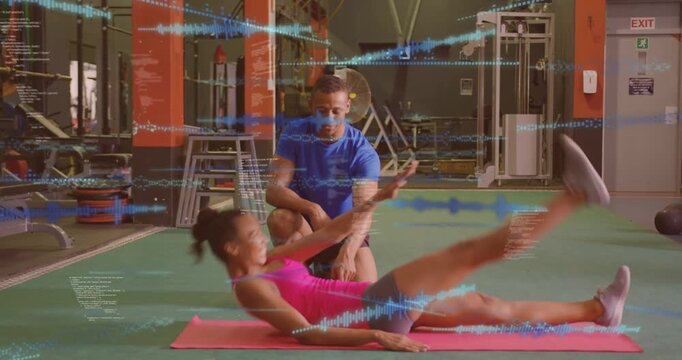 Animation of data processing over fit woman performing exercise with male trainer at gym