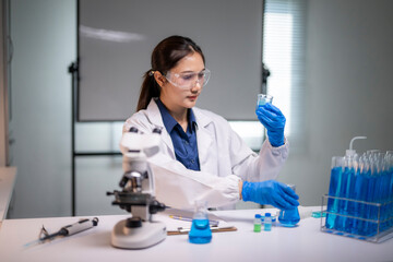 Fototapeta premium Female scientist conducting research experiment in laboratory