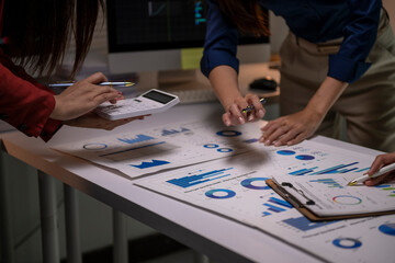 Fototapeta premium Businesswomen analyzing financial data, calculating marketing strategy
