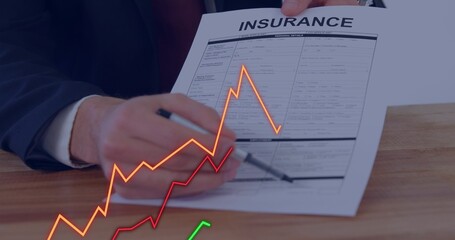 Pointing suited hands highlighting INSURANCE form at office table, with pen and colored graphs