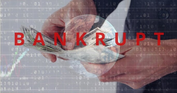 Counting suit-cuffed hands holding USD cash under globe with BANKRUPT and binary chart in office