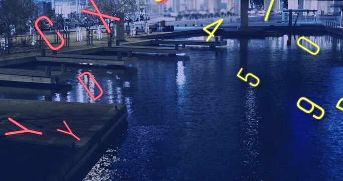 Reflecting water surface with piers and neon numerals at nighttime marina, visitors wearing coats