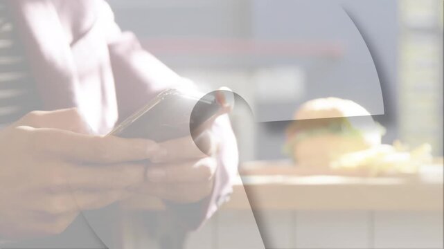 Man holding phone at cafe counter, thumbs tapping causing circular graphic revealing app