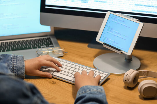Male programmer working at table in office, closeup