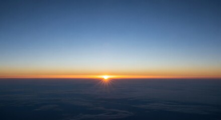 Fototapeta premium Sunrise over calm ocean horizon with golden sky