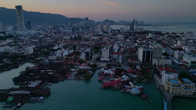 George Town Penang clan jetties cityscape at dusk. Smooth aerial view drone
