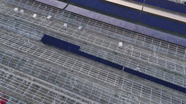 Developing a major solar power plant using photovoltaic panels in a vast agricultural field near a highway, focusing on renewable energy infrastructure and sustainability incentives